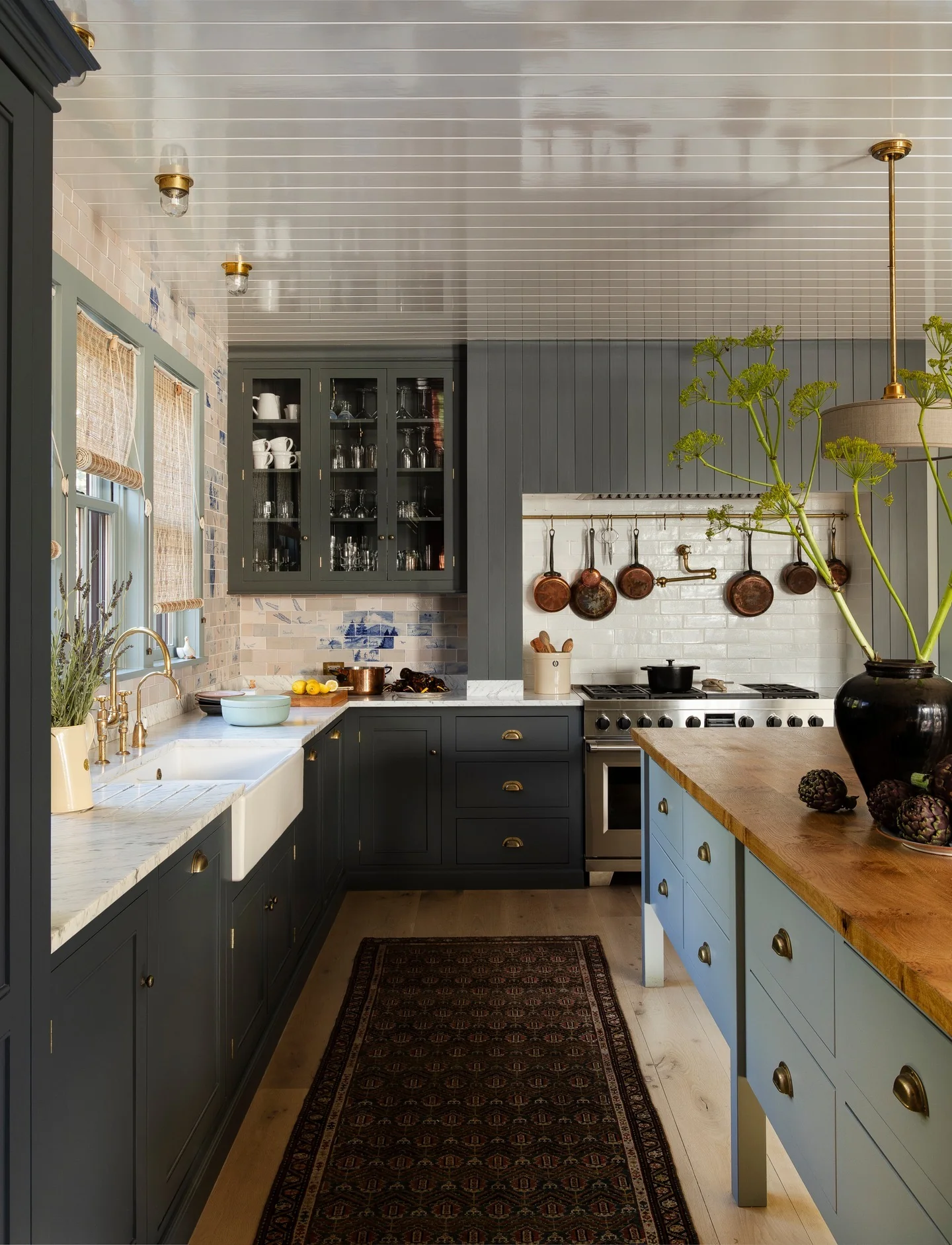 Hanging Copper Pots Add Warmth Above the Range